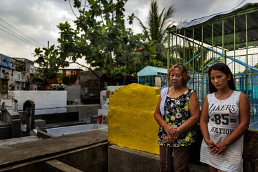 Amanda Gonzales, 72, (left) leads Jhoy Medina, 26, (right) on the 9th day of prayer following the death of her brother. The prayers are a religious custom whereby Filipinos commemorate the dead. Jhoy...