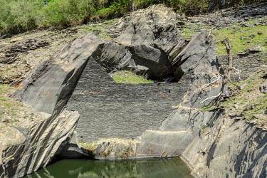 A wall, normally submerged, in the dried bed of Lac de Guerledan, drained in 2015 to enable maintenance. The artificial lake was excavated to create a reservoir to supply a hydro-electric station and...