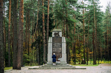 A visitor reads the Hebrew inscription on a memorial to those murdered in the 'Ponary Massacre' during WW2. The village of Paneriai, whose Yiddish name was Ponar, is now a forested suburb of the capit...