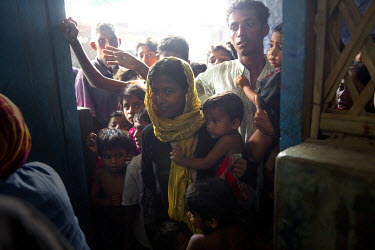 Rohingya refugees queue up for a meal supplied by an aid agency at the Kutupalong refugee camp where new arrivals have often not eaten for days.   The United Nations reported that by 11 September 2017...