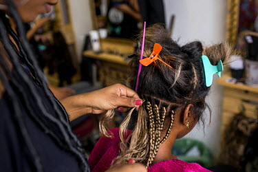 Roberta Marinho, 28, gets box braids at the AfroAtitude salon, in Rio's north side, one of many new black-owned small businesses in the region.