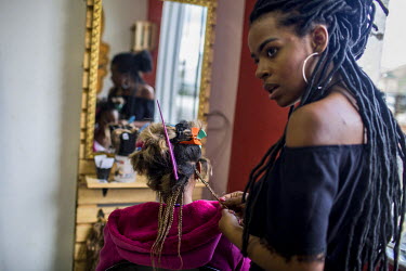 Hair stylist Alessandra Rodrigues, 23, says she has noticed a 'huge rise' in the number of black Brazilian women choosing braids and natural hairstyles in the past five years. 'It's part of embracing...