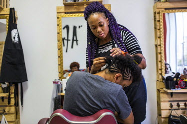 Fernando Mendes, 21, has braids made by Juliana Marinho, the director of the AfroAtitude salon, located in the Madureira neighborhood in the heart of Rio's North side. Fernando says he is the only one...