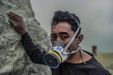 Miskadi, 36, in the crater of the Ijen volcano, where he has worked as a sulphur miner for over 15 years. He calculates that he has climbed the crater over 6,000 times, each time carrying over his own...