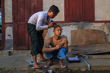 Sai Lwin (AKA Shan Lay), 19, gets his hair cut by one of the youth volunteers at a Pat Jasan centre. Shan Lay came from the town of Moe Hnyin and has been selling heroin and other drugs in Myitkyina s...