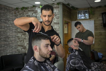 Barber Aram Rahim (35) cutting hair in his shop in the town centre. Prior to the 2017 General Election he was asked what he thought were the main issues affecting the local area. Rahim replied: 'I'm g...
