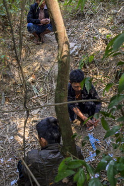 Ar Kaw (R), a 23 year old ethnic Kachin prepares to inject heroin in bushes behind the house where he lives with his mother in a village in Wine Maw. Ar Kaw, who used to be a farmer, has been addicted...