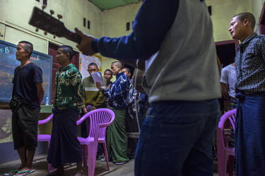 Young drug addicts, mostly ethnic Kachin, sing devotional songs while a youth volunteer plays guitar during devotion time at a Pat Jasan detention centre for drug addicts.  Pat Jasan is a church-based...