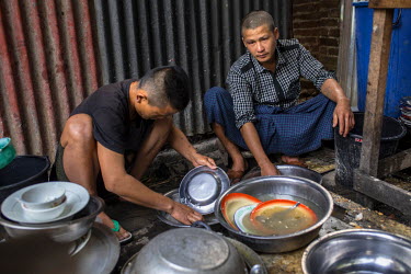 Zau Rein Awng (R), a 23 year old Kachin, washing dishes at a Pat Jasan centre. Awng was working in the jade mines in Hpakant where he also became addicted to heroin. He was arrested on the Valentine's...
