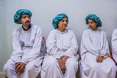 From left to right: Murtaza Ghulum, Zamurrad Bibi and Kausar Shaheen sit together before their operations to remove cataracts, at the LRBT Eye Hospital in Mandra.