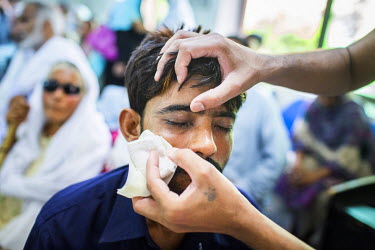 Murtaza Ghulum (30) has his bandage removed a day after his cataract operation at the LRBT Eye Hospital in Mandra.