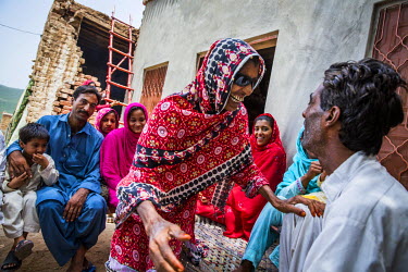 Kausar Shaheen shares a joke with her husband Shauket Ali, at their home in Manhiala, Chakwal District. Kausar had an operation to remove a cataract from her right eye four days earlier and must wear...