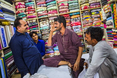Murtaza Ghulum (30) talks with friends in the market after his operation to remove the cataract in his right eye. Murtaza suffered from bilateral cataracts and was forced to leave his job in Saudi Ara...