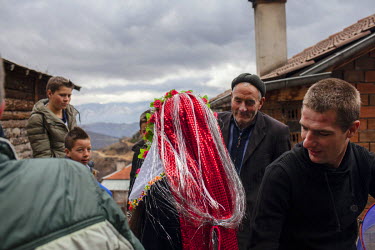 Groom Refat Rvdikov (right) and the bride Letve Osmanova, along with extended family and friends from the groom's family leave a house on the way to the centre of the village to dance a traditional 'h...