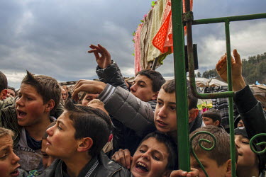 The men and boys from the village of Ribnovo gather in front of groom Refat Avdikov's home where the women of the family are ready to give out flags, textiles and wedding gifts to be carried through t...