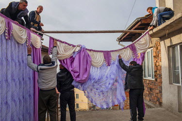 Outside the bride's family house relatives and close friends construct a temporary ritual bedroom which apes the real one inside. The attention to detail and the amount of wedding presents that fill t...