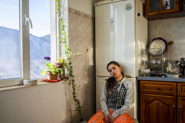 Atidje Serdearvi sits in her parent's kitchen.