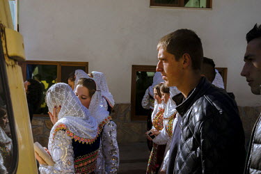 Villagers gather in the village centre during celebrations for a wedding.