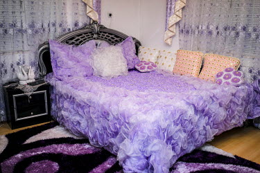 A new bed and bedroom furnishings in the family home of young man who is about to be married.
