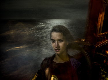 Omayma, 21, from Morocco, photographed in international waters mid-way between Libya and Italy, in the Mediterranean Sea.  'I had a lot of problems with my father, as did all my siblings. He was a dru...
