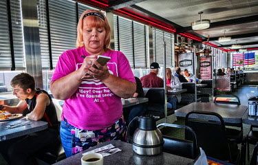 Sam, the owner of Summit diner, takes a breakfast order.