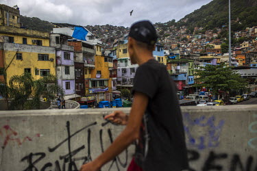 People cross a pedestrian bridge in Rocinha, the largest single favela in Rio de Janeiro.