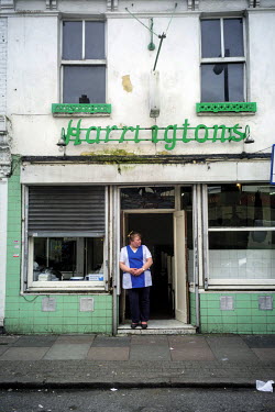 Jackie waits for customers outside Harringtons Pie and Mash shop during an afternoon lull.