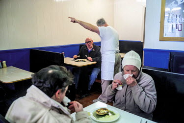 Robert Kelly talks to a regular customer at SR Kelly's pie and mash shop on the Bethnal Green Road.