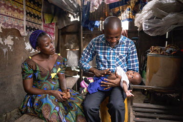 Hosea Sosu, a practitioner of traditional medicine, makes a home visit to check a new mother and her baby. Sosu lives and works on the Makoko waterfront, a slum area consisting of wooden buildings on...