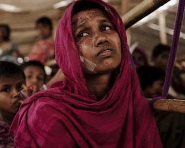 Her face heavily bandaged, Momtaz Begum told how government soldiers came to her village demanding valuables.   "I told them I was poor and had nothing. One of them started beating me saying, 'If you...