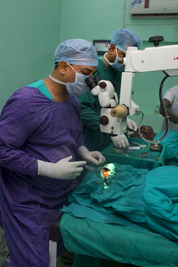 A surgeon carries out cataract operation in the Laxman Hospital.