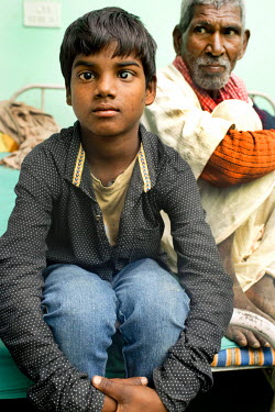 A boy with a cataract waits to be seen at the Laxman Hospital.
