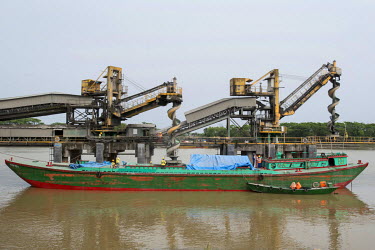 Loading cement onto a ship on the Surma River at Chhatak, the location of Lafarge Surma Cement Ltd, the largest cement factory in Bangladesh.