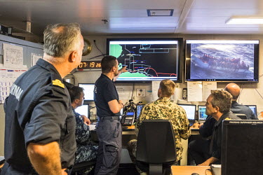 Admiral Javier Moreno looks on as officials from Spain and other European countries prepare for a multiple rescue operation in the CEICE control room onboard the Spanish navy vessel the Cantabria.