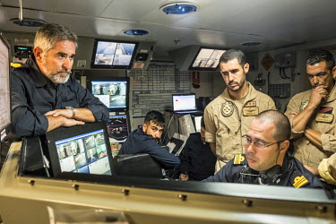 Commander Jose Maria Fernandez de la Puente Millan (left) meets with helicopter pilots in the CEICE control centre, shortly before embarking on a multiple rescue operation in the Mediterranean Sea, on...