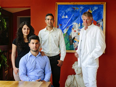 Architect Lars Asklund hosts Syrian refugee Farah Hilal, her husband, Waleed Lababidi and her brother Milad Hilal (seated). Farah, Milad and Waleed became internally displaced long before they left Sy...