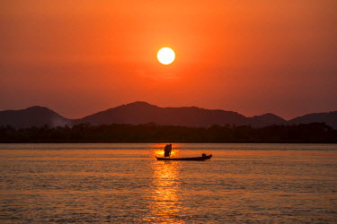A fisherman on the Salween River at sunset.