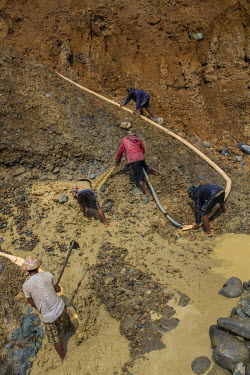 A team of miners working at an illegal gold mine near Indawgyi Lake. The team, led by chief miner Win Oo, the eldest among them, works at a daily rate that can be as low as 5000 Kyats (about GBP 3.00)...