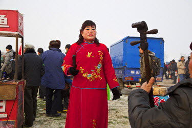 A traditional storyteller, accompanied by a musician, performs at the Ma Jie folk festival.   For centuries farmers in Henan have gathered during Chinese New Year in the region's wheat fields to liste...