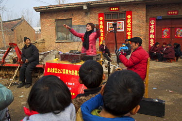 Storyteller Zhao Tao performs at a village soon after she appeared at the Ma Jie folk festival. For centuries farmers in Henan have gathered during Chinese New Year in the region's wheat fields to lis...