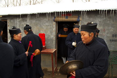 Taoist priests make a blessing at the Ma Jie folk festival.For centuries farmers in Henan have gathered during Chinese New Year in the region's wheat fields to listen to bards singing and recounting o...
