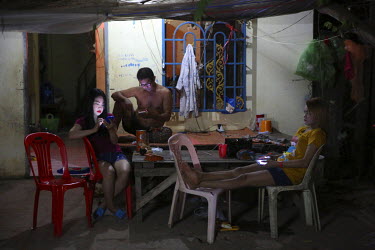 Sex workers outside a Battambang massage parlour.