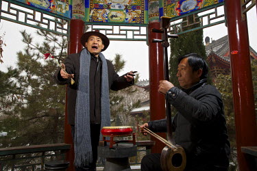 Traditional storyteller Master Li (left) and his accompanying musician Mr Deng perform in a temple.