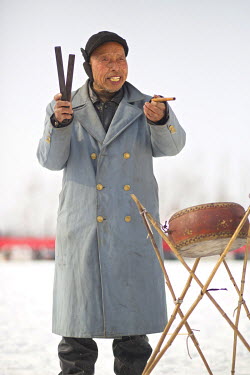 A traditional storyteller performs at the Ma Jie folk festival. For centuries farmers in Henan have gathered during Chinese New Year in the region's wheat fields to listen to bards singing and recount...