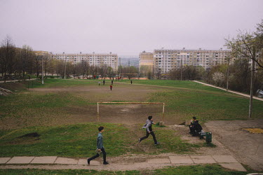 Children playing beside a football pitch in the Ciocana district.