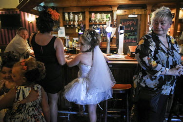 Irish Travellers celebrate Viviana Sheridan and her brothers' First Holy Communion in the The Pressers Arms public house.