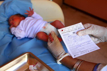 A medic checks the identity details of a baby in the neonatology unit at the Ghassani Hospital.