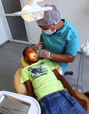 A dentist examines the teeth of a child who is resident at the 'Akkari' centre, a home for abandoned children and orphans. The centre offers a shelter to 225 boys from 5 to 18 years old.