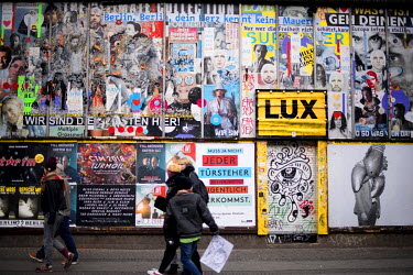 A wall covered in advertisments in Kreuzberg, a district undergoing significant redevelopment and gentrification.