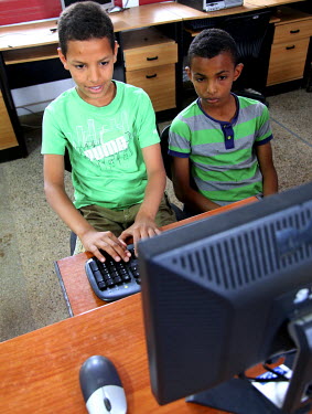 Two boys use a computer at the 'Akkari' centre, a home for abandoned children and orphans. The centre offers a shelter to 225 boys from 5 to 18 years old.